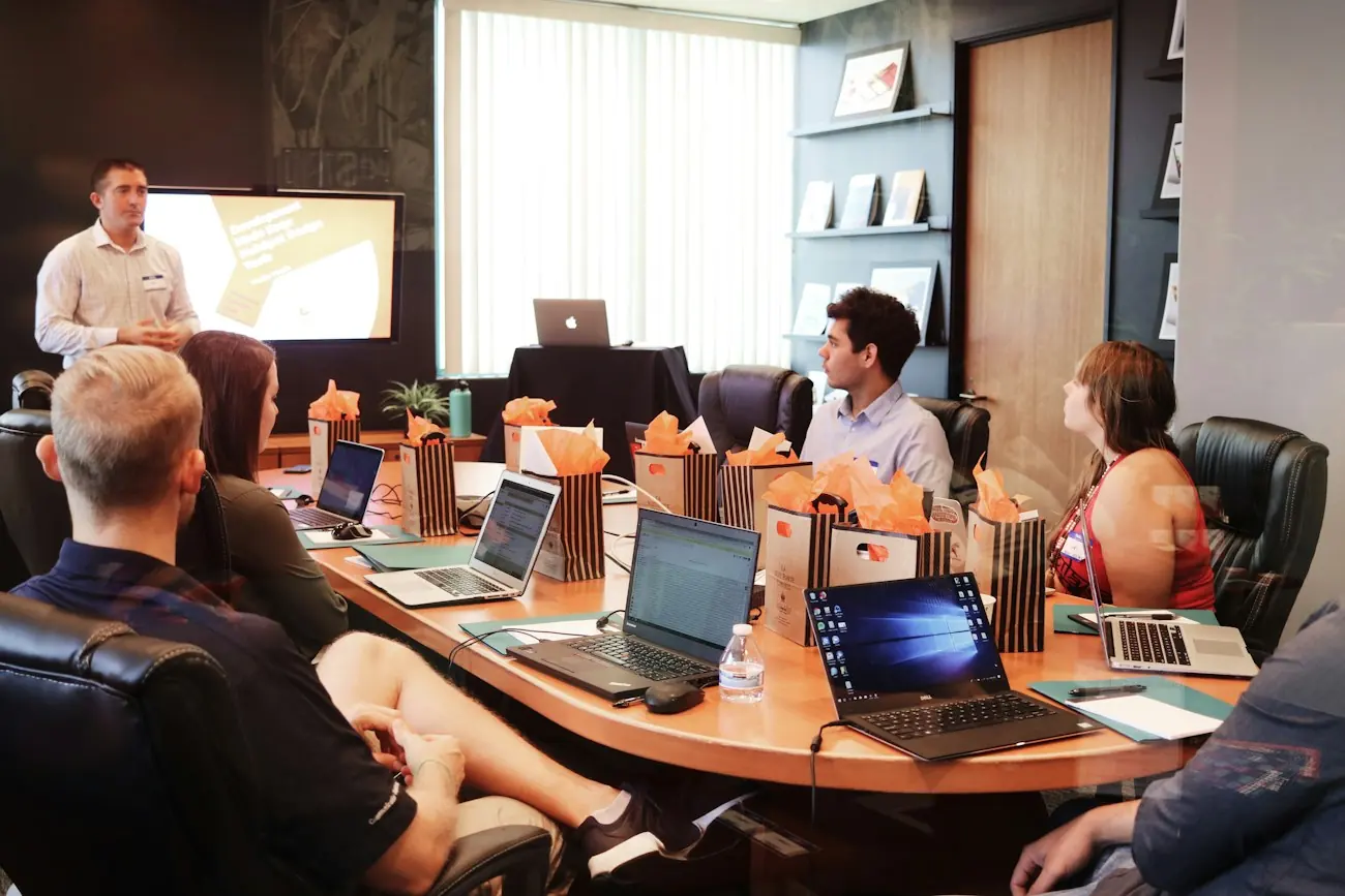 A team discussing business requirements around a meeting table